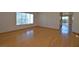 Spacious living area with hardwood floors, large window, and sliding glass door at 1220 Padre Serra Ln, Las Vegas, NV 89134