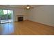 Spacious living room features hardwood floors, a ceiling fan, and a sliding door to the backyard at 1220 Padre Serra Ln, Las Vegas, NV 89134