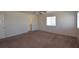 Large primary bedroom featuring neutral carpet, ceiling fan, and natural light at 1220 Padre Serra Ln, Las Vegas, NV 89134