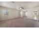 Large main bedroom featuring neutral walls, carpet, ceiling fan, and an open floor plan at 1220 Padre Serra Ln, Las Vegas, NV 89134