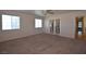 Spacious primary bedroom with carpet, ceiling fan, and french doors to another room at 1220 Padre Serra Ln, Las Vegas, NV 89134