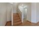 Wooden staircase leading to the upper level, complemented by neutral walls and hardwood flooring at 1220 Padre Serra Ln, Las Vegas, NV 89134