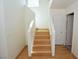 Bright staircase with wooden steps and white railings leading to the upper level at 1220 Padre Serra Ln, Las Vegas, NV 89134
