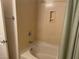 Bathroom featuring a tub with white tile and a shower head at 15 E Agate Ave # 202, Las Vegas, NV 89123