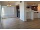 Inviting dining area featuring wood flooring, a modern chandelier, and convenient access to the kitchen at 15 E Agate Ave # 202, Las Vegas, NV 89123