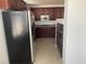 A partial view of the kitchen with stainless steel appliances and dark cabinetry at 15 E Agate Ave # 202, Las Vegas, NV 89123