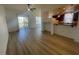 Bright living room with light wood flooring and large windows with an adjoined view of the kitchen at 15 E Agate Ave # 202, Las Vegas, NV 89123