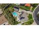 Aerial view of property, lush landscaping, pool, solar panels, and spacious driveway at 15 Pheasant Ridge Dr, Henderson, NV 89014