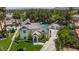 Aerial view showcasing the house's layout, including a pool, manicured lawn and mature trees at 15 Pheasant Ridge Dr, Henderson, NV 89014