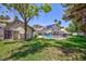 Expansive backyard with pool, lush lawn, mature trees and desert landscaping at 15 Pheasant Ridge Dr, Henderson, NV 89014