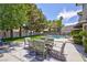 Inviting backyard patio area with outdoor seating and views of the pool and lush greenery at 15 Pheasant Ridge Dr, Henderson, NV 89014