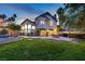 Spacious backyard with lush lawn, mature trees, and outdoor dining area at 15 Pheasant Ridge Dr, Henderson, NV 89014