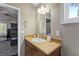 Bathroom features a wooden vanity, and open door to bedroom with bunk beds and plantation shutters at 15 Pheasant Ridge Dr, Henderson, NV 89014