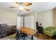 Bedroom with a ceiling fan, hard wood floors, green accent chair and office furniture at 15 Pheasant Ridge Dr, Henderson, NV 89014