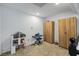 Carpeted bonus room with toy dollhouse, keyboard, cabinets, and overhead lighting at 15 Pheasant Ridge Dr, Henderson, NV 89014