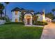 Beautiful two-story home with manicured lawn, trimmed hedges and mature landscaping at 15 Pheasant Ridge Dr, Henderson, NV 89014