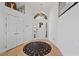 Bright foyer with white walls, wood floors, and a striking round rug at 15 Pheasant Ridge Dr, Henderson, NV 89014