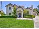 Charming two-story home featuring a lush green lawn and well-maintained landscaping in a suburban setting at 15 Pheasant Ridge Dr, Henderson, NV 89014