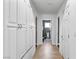 Hallway with a wood-look floor, and a tall storage cabinet running the length of the hallway at 15 Pheasant Ridge Dr, Henderson, NV 89014
