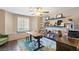 Home office with desk, ceiling fan, bookshelf, decorations, window and hardwood floors at 15 Pheasant Ridge Dr, Henderson, NV 89014