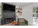 Cozy living room with fireplace, built in shelving, and a comfortable reading chair at 15 Pheasant Ridge Dr, Henderson, NV 89014
