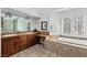 Large bathroom offering a double vanity, soaking tub and step-in shower with glass door at 15 Pheasant Ridge Dr, Henderson, NV 89014