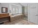 Well-lit ensuite bathroom featuring a tub, glass enclosed shower and built-in desk area at 15 Pheasant Ridge Dr, Henderson, NV 89014