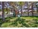 Backyard featuring a charming wooden playset with slide and swing for Gathering fun at 15 Pheasant Ridge Dr, Henderson, NV 89014