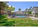 Refreshing pool area with secure fencing and lush landscaping, perfect for outdoor relaxation and recreation at 15 Pheasant Ridge Dr, Henderson, NV 89014
