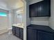 Bathroom with vanity, blue cabinets, and shower/tub combination at 1509 Linnbaker Ln # 102, Las Vegas, NV 89110