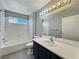 Bathroom featuring a single sink vanity and shower-tub combination at 1509 Linnbaker Ln # 102, Las Vegas, NV 89110
