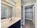 Bathroom vanity with modern fixtures, lighting, and a view into the large walk-in closet at 1509 Linnbaker Ln # 102, Las Vegas, NV 89110