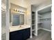 Bathroom vanity with modern fixtures, lighting, and a view into the large walk-in closet at 1509 Linnbaker Ln # 102, Las Vegas, NV 89110