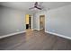 Large bedroom with sleek floors, a ceiling fan, and an attached bathroom at 1509 Linnbaker Ln # 102, Las Vegas, NV 89110
