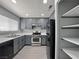 Modern kitchen with gray cabinets, stainless steel appliances, and LVP flooring at 1509 Linnbaker Ln # 102, Las Vegas, NV 89110