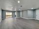 Spacious living room with new gray vinyl flooring, recessed lighting, and a sliding glass door at 1509 Linnbaker Ln # 102, Las Vegas, NV 89110