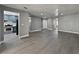 Open concept living room with kitchen view featuring stainless steel appliances and gray cabinets at 1509 Linnbaker Ln # 102, Las Vegas, NV 89110