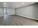 Bright, open living room with gray walls, and luxury vinyl plank flooring at 1509 Linnbaker Ln # 102, Las Vegas, NV 89110