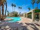 Inviting community pool surrounded by lush landscaping and palm trees at 1509 Linnbaker Ln # 102, Las Vegas, NV 89110