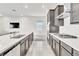 Modern kitchen featuring gray cabinets, stainless steel appliances, and marble countertops at 1596 Pacific Baza St, Las Vegas, NV 89138