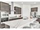 Modern kitchen featuring gray cabinets, stainless steel appliances, and an island with marble countertops at 1596 Pacific Baza St, Las Vegas, NV 89138
