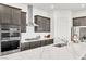 Modern kitchen featuring gray cabinets, stainless steel appliances, and an island with marble countertops at 1596 Pacific Baza St, Las Vegas, NV 89138