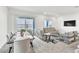 Open-concept living room featuring comfortable seating, a large TV, and a dining area at 1596 Pacific Baza St, Las Vegas, NV 89138