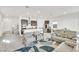 Bright open-concept living room featuring modern furnishings and a view of the kitchen and dining areas at 1596 Pacific Baza St, Las Vegas, NV 89138