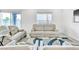 Bright living room featuring plush seating, a stylish accent rug, and sliding glass doors at 1596 Pacific Baza St, Las Vegas, NV 89138