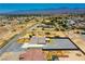 Desert property featuring a home with a large fenced lot, metal awning, and mountain backdrop at 1801 S Manzanita Dr, Pahrump, NV 89048