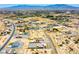 An aerial view shows properties with desert landscaping across a developing community with mountain views at 1801 S Manzanita Dr, Pahrump, NV 89048