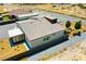 Aerial view of house, backyard, RV parking and desert landscape beyond the chain link fence at 1801 S Manzanita Dr, Pahrump, NV 89048