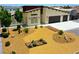 Aerial view of a charming tan-colored single-story home with a well-maintained desert front yard at 1801 S Manzanita Dr, Pahrump, NV 89048