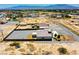 Aerial view of modern house in desert neighborhood featuring fencing, awnings, and landscaping at 1801 S Manzanita Dr, Pahrump, NV 89048
